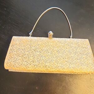Vintage unique lacy cream with silver glitter clutch purse. Faux pearls clasp.